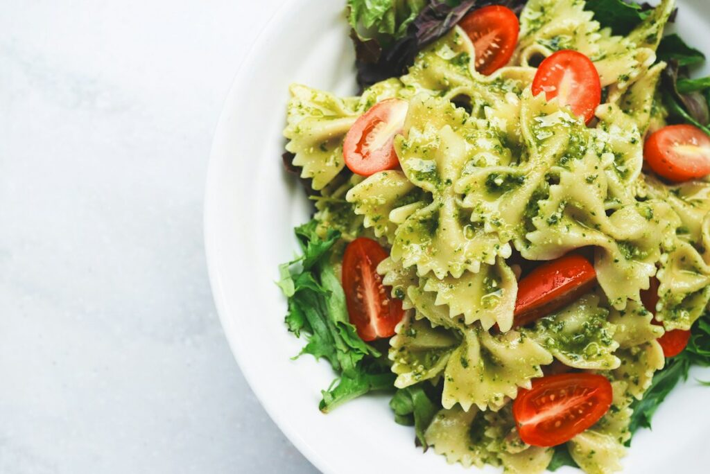 High protein pasta with chicken and vegetables in a white bowl