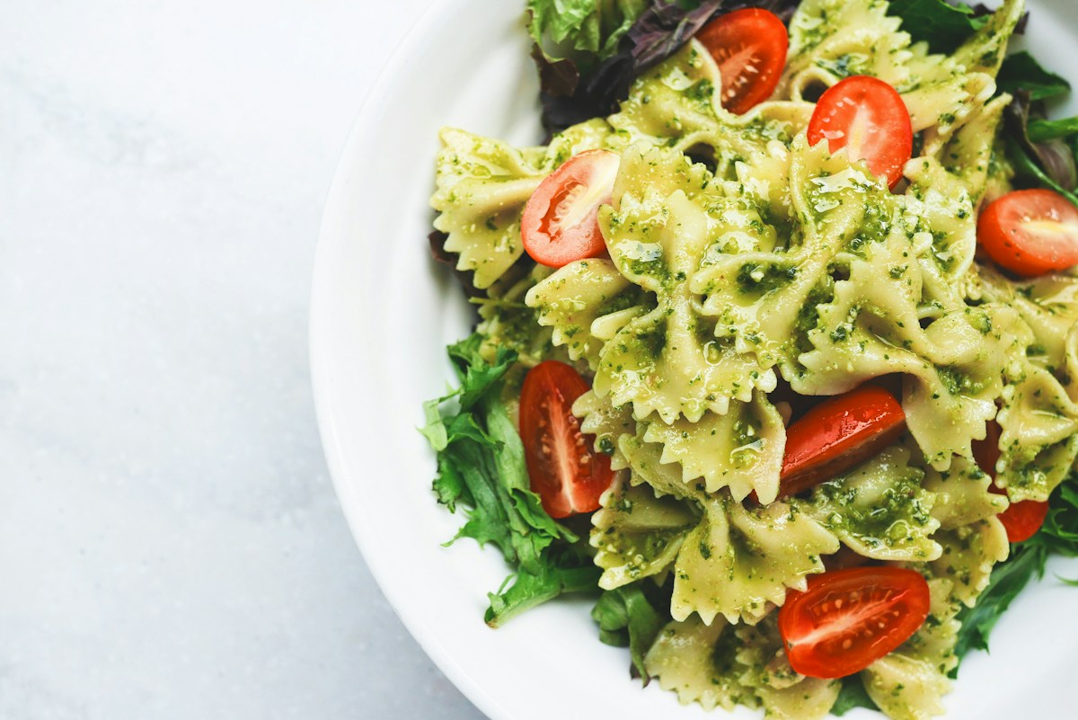 High protein pasta with chicken and vegetables in a white bowl